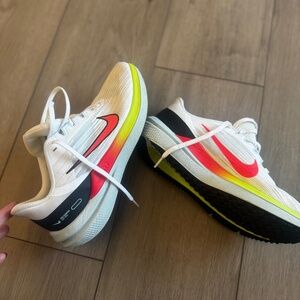 Nike Air Winflo 9 running shoes in a white, black, and total orange.  Size